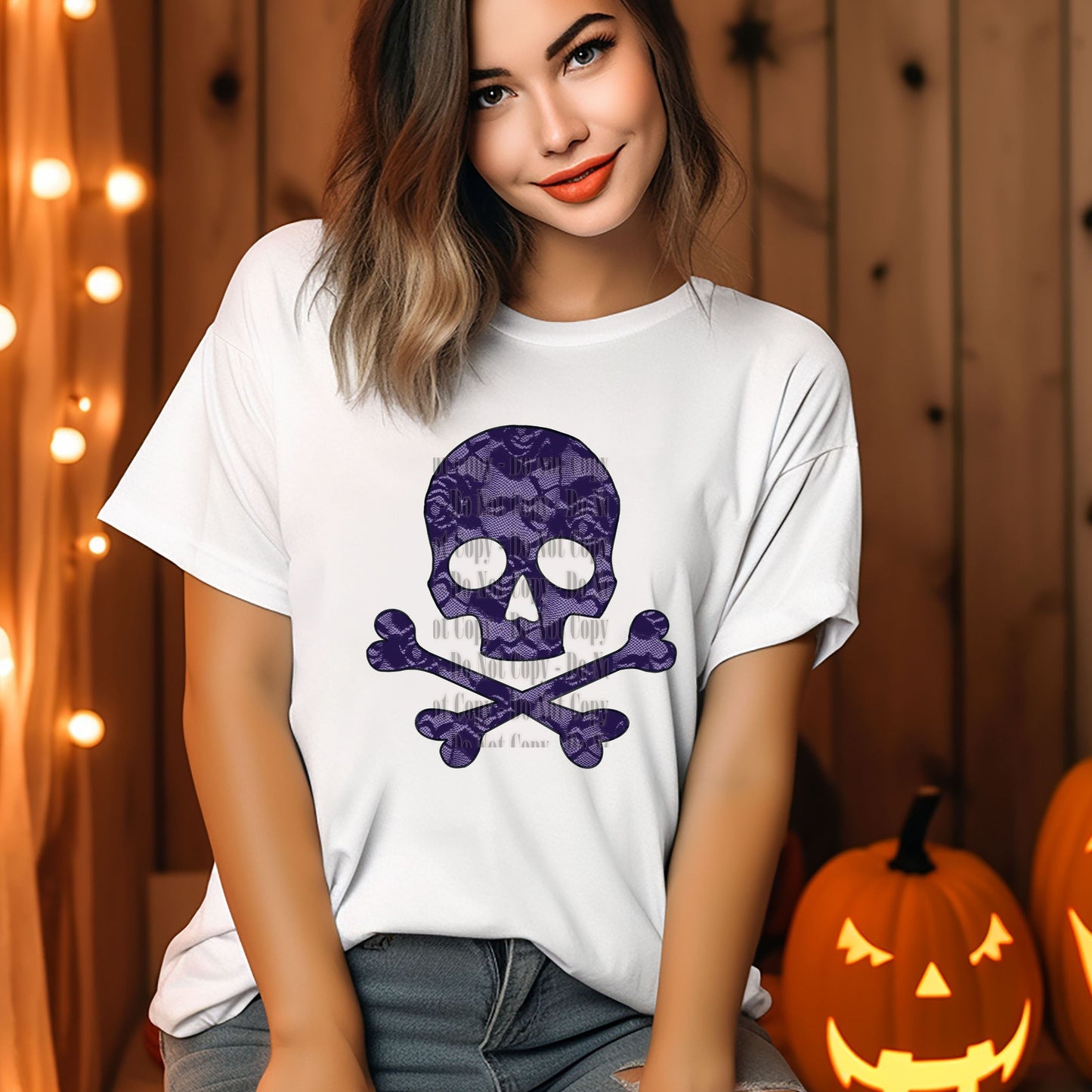 A woman wearing a white t-shirt with a digital design of a purple lace skull on the front, posing against a backdrop with pumpkins and wooden elements.